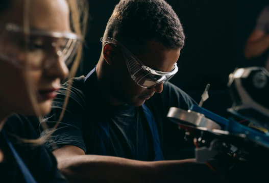 Engineers working on manufacturing equipment